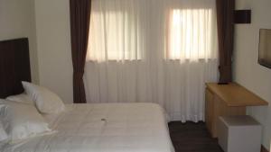 Postel nebo postele na pokoji v ubytování Hotel Garni Vittoria