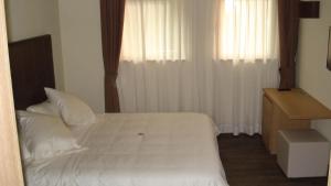 Postel nebo postele na pokoji v ubytování Hotel Garni Vittoria