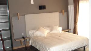 Postel nebo postele na pokoji v ubytování Hotel Garni Vittoria