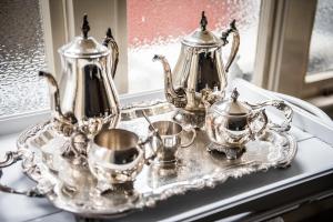 a silver tray with two tea pots and cups on it at The Grange B&B in Christchurch