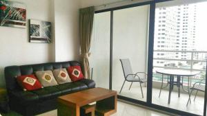 a living room with a couch and a table at Studio View Talay 5C in Pattaya South