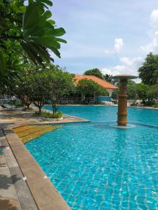 a swimming pool with a fountain in a resort at Studio View Talay 5C in Pattaya South