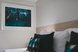 a bed with a picture of a man on it at Spicers Potts Point in Sydney