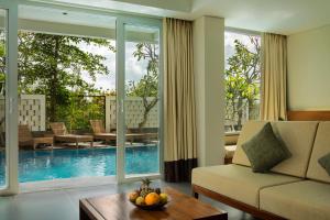 a living room with a couch and a table at Paragon Hotel Seminyak in Seminyak