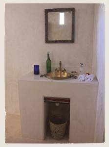 a bathroom with a sink and a mirror at Andavelo House in Lamu