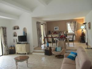 a living room with a couch and a table at L'Oustau de Bigatié in Lambesc