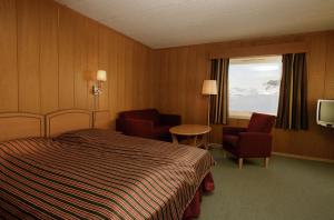 Säng eller sängar i ett rum på Rødungstøl Høyfjellshotell