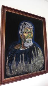a painting of a man with a beard in a frame at The Lake Motel in Taupo