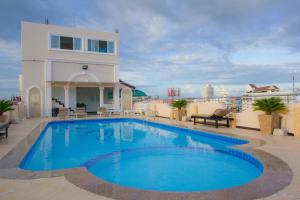 a swimming pool on the roof of a building at LK Mansion in Pattaya