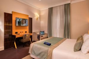Ένα ή περισσότερα κρεβάτια σε δωμάτιο στο Hotel Gioberti