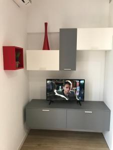 a tv sitting on a shelf in a room at P&D Apartments Navigli in Milan