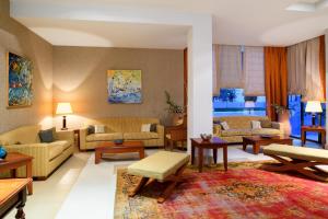 a large living room with couches and tables at Alexandra Beach Spa Resort in Potos