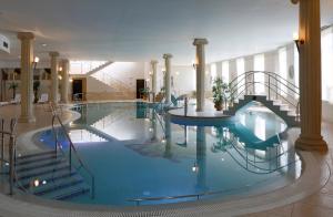a swimming pool with a slide in a building at Bristol Georgy House in Karlovy Vary