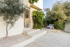 a white house with stairs leading to a door at Follow the Sun in Cagliari