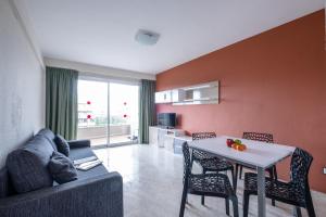 a living room filled with furniture and a table at Apartamentos California in Salou