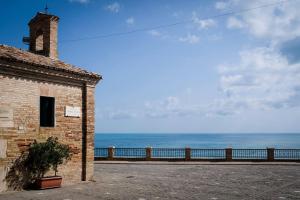 a brick building with a view of the ocean at Cortile nel borgo in Marina Palmense