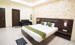 Letto o letti in una camera di Treebo King'S Court Chandrasekharpur