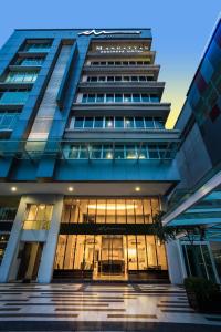 um edifício azul alto com muitas janelas em Manhattan Business Hotel TTDI em Petaling Jaya