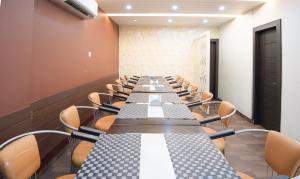 a long conference room with a long table and chairs at Treebo Trend King'S Court Chandrasekharpur in Bhubaneshwar