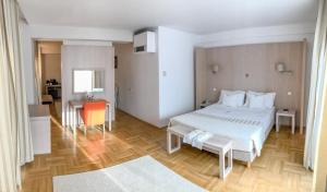 サトゥ・マーレにあるHotel Satu Mare Cityのウッドフロアのベッドルーム1室(大きな白いベッド1台付)