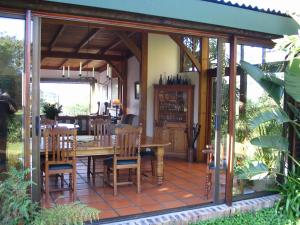 a screened in dining room with a table and chairs at Four Fields Farm in The Crags