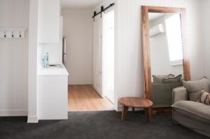 a living room with a couch and a table at Anchor Geelong in Geelong
