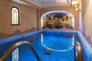 a swimming pool in a house with a blue floor at Chuvashia Hotel in Cheboksary