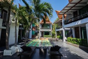 a swimming pool in the backyard of a house with palm trees at Cocohut Beach Resort Koh Phangan in Haad Rin
