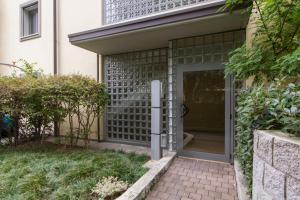 a front door of a home with a brick walkway at Parco di Monza Apartment in Monza