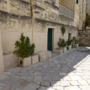 a building with potted plants in front of a door at Casa Elena in Matera
