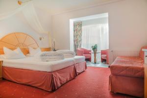 Postel nebo postele na pokoji v ubytování Alpenhotel Regina