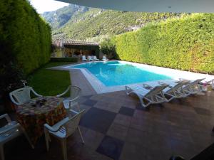 a swimming pool with chairs and a table and a table and chairs at Diamond Apartments in Agios Konstantinos