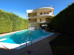 um edifício com piscina em frente a um edifício em Diamond Apartments em Agios Konstantinos Fthiotida