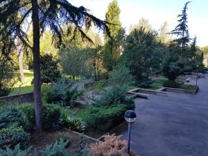 a park with benches and trees and a street light at A casa tua B&B in Rome