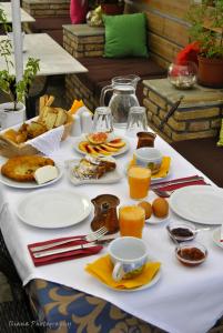 a table with plates of food and drinks on it at Filoxenia Studios in Galaxidi