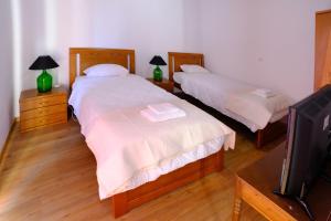 Postel nebo postele na pokoji v ubytování Quinta do Fragoso