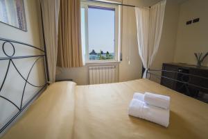 Łóżko lub łóżka w pokoju w obiekcie La Terrazza