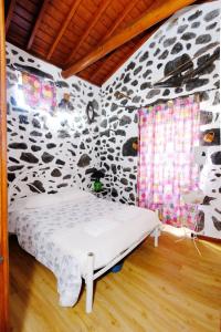 a bedroom with a bed in a stone wall at Quinta do Fragoso in Alto do Sul +21 photos