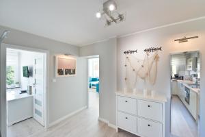 a bathroom with a sink and a mirror at Pomorskie Apartamenty Ceynowy 1 Deluxe in Sopot