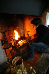 un homme assis devant une cheminée dans l'établissement La Riserva Montebello, à Bolsena