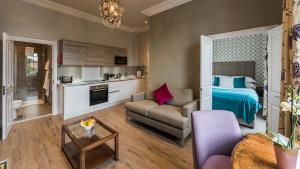 a living room with a bed and a couch at Beech House - Urban Apartments in Bristol