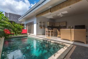 a swimming pool in the middle of a house at Castro Villa in Seminyak