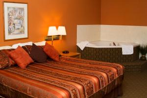 A bed or beds in a room at Cottonwood Inn & Suites