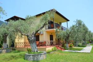 a house with trees in front of it at Hotel Maria in Chrysi Ammoudia