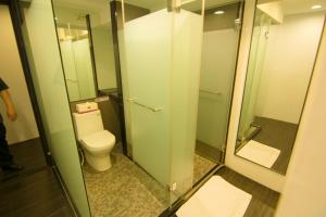 a bathroom with a toilet and a glass door at Zhongxiao Dunhua Homestay in Taipei