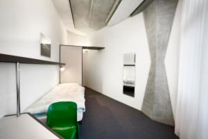 A bed or beds in a room at CIP Hôtel