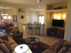 a living room with a couch and a flat screen tv at Kissimmee Area Pool Home in Orlando