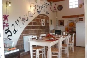 a kitchen with a table and a brick wall at B&B Santu Larentu in Ozieri