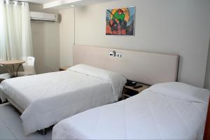 Un pat sau paturi într-o cameră la Hotel Sabino Palace