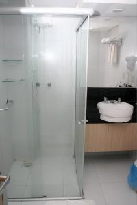 a bathroom with a shower and a sink at Hotel Sabino Palace in Mossoró